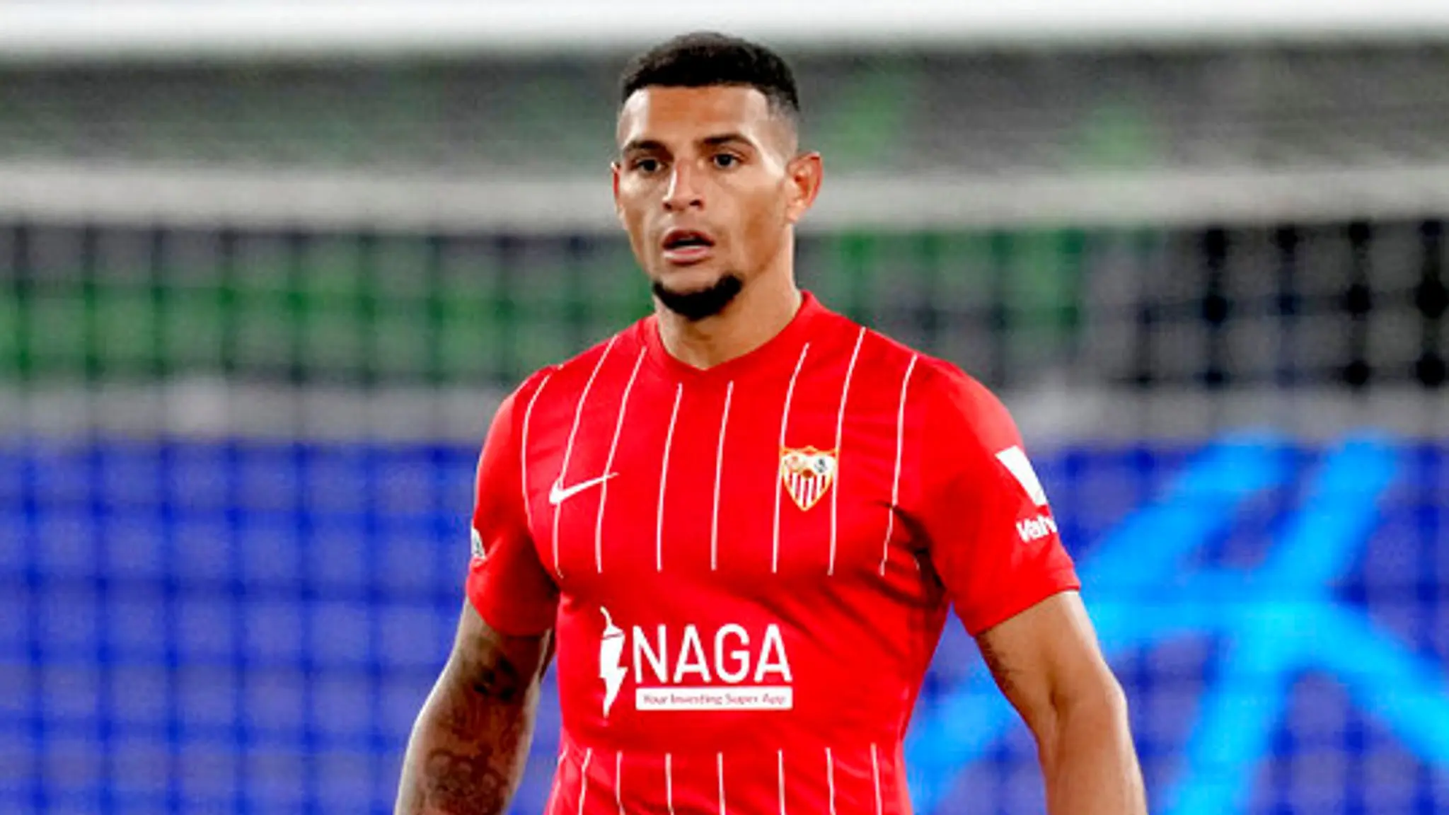 Diego Carlos in a red Sevilla FC jersey during a football match.