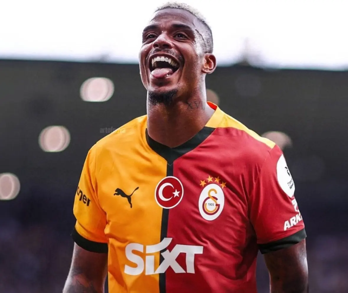 Mario Lemina celebrating in Galatasaray's yellow and red jersey on the field.