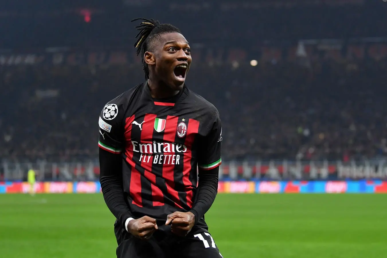 Rafael Leao celebrating with excitement in an AC Milan jersey during a match.