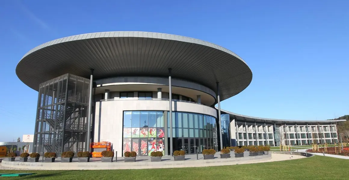 Modern building of TFF Riva Tesisleri with a large overhanging roof.